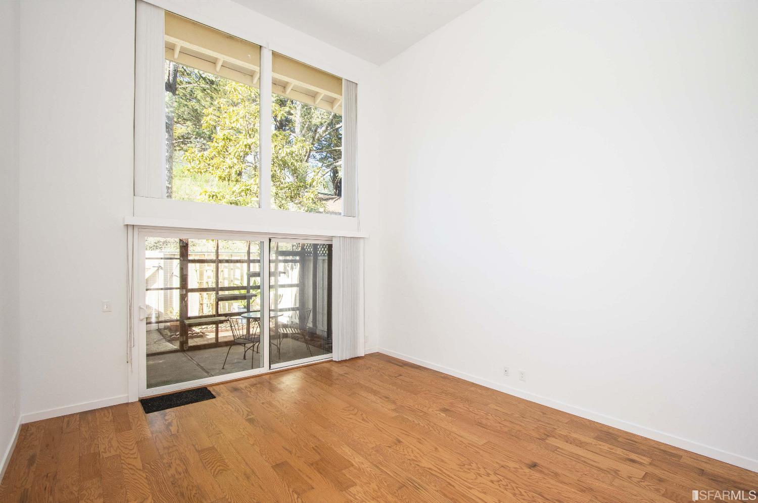 1253 Terra Nova Boulevard Pacifica, CA 94044 - Photo 2 of 23 an empty room with wooden floor and windows