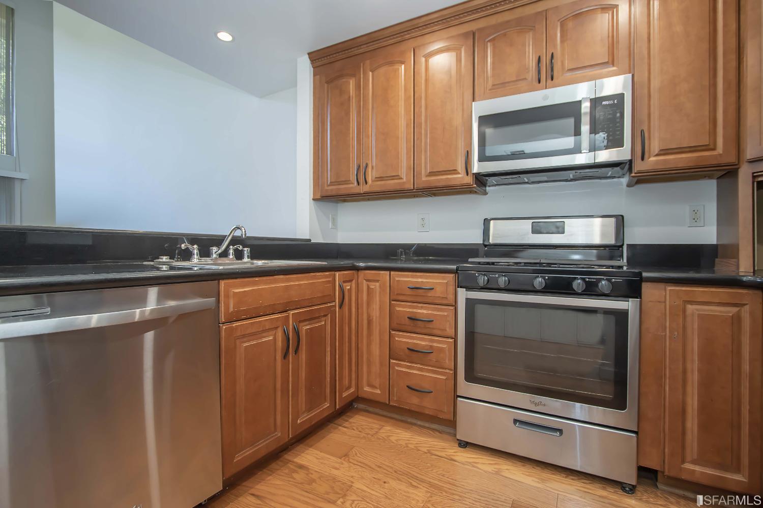 1253 Terra Nova Boulevard Pacifica, CA 94044 - Photo 7 of 23 a kitchen with stainless steel appliances granite countertop a stove microwave and cabinets