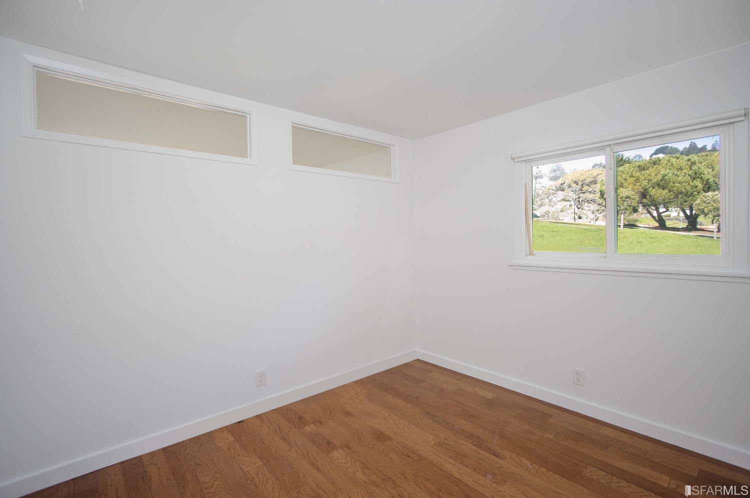 1253 Terra Nova Boulevard Pacifica, CA 94044 - Photo 9 of 23 a view of an empty room with wooden floor and a window