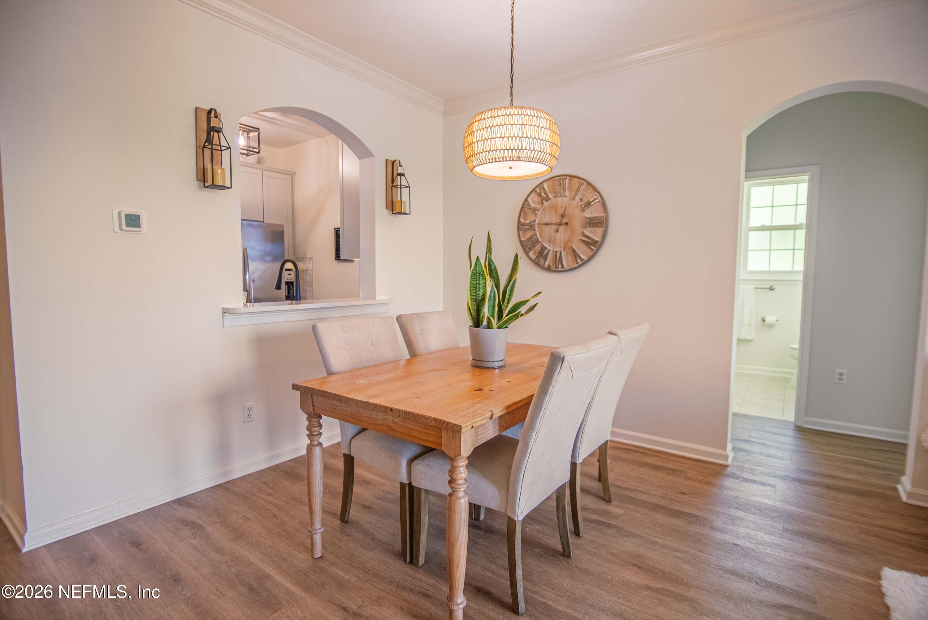 7990 Baymeadows Road East, Unit 823 Jacksonville, FL 32256 - Photo 11 of 45 a view of a dining area with furniture and wooden floor