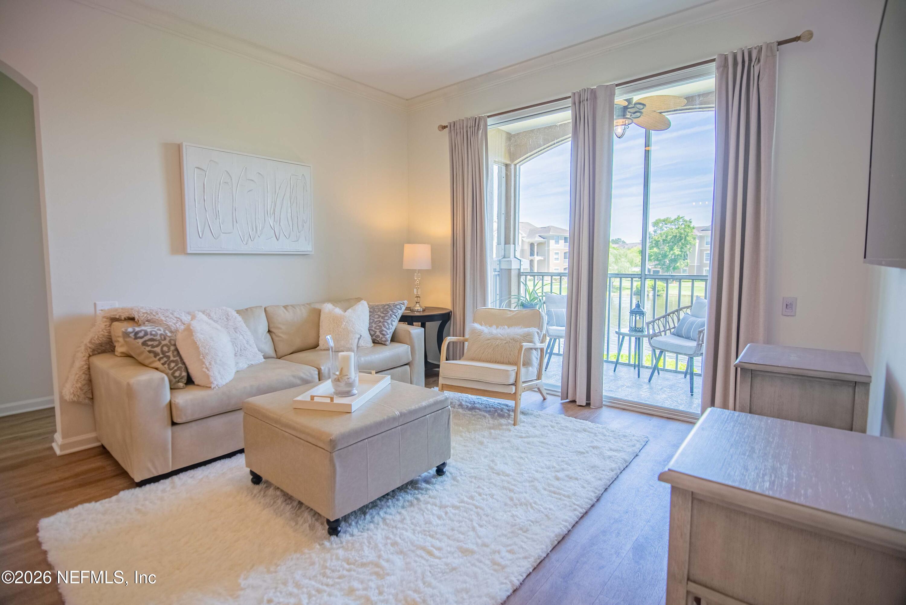 7990 Baymeadows Road East, Unit 823 Jacksonville, FL 32256 - Photo 12 of 45 a living room with furniture and a large window