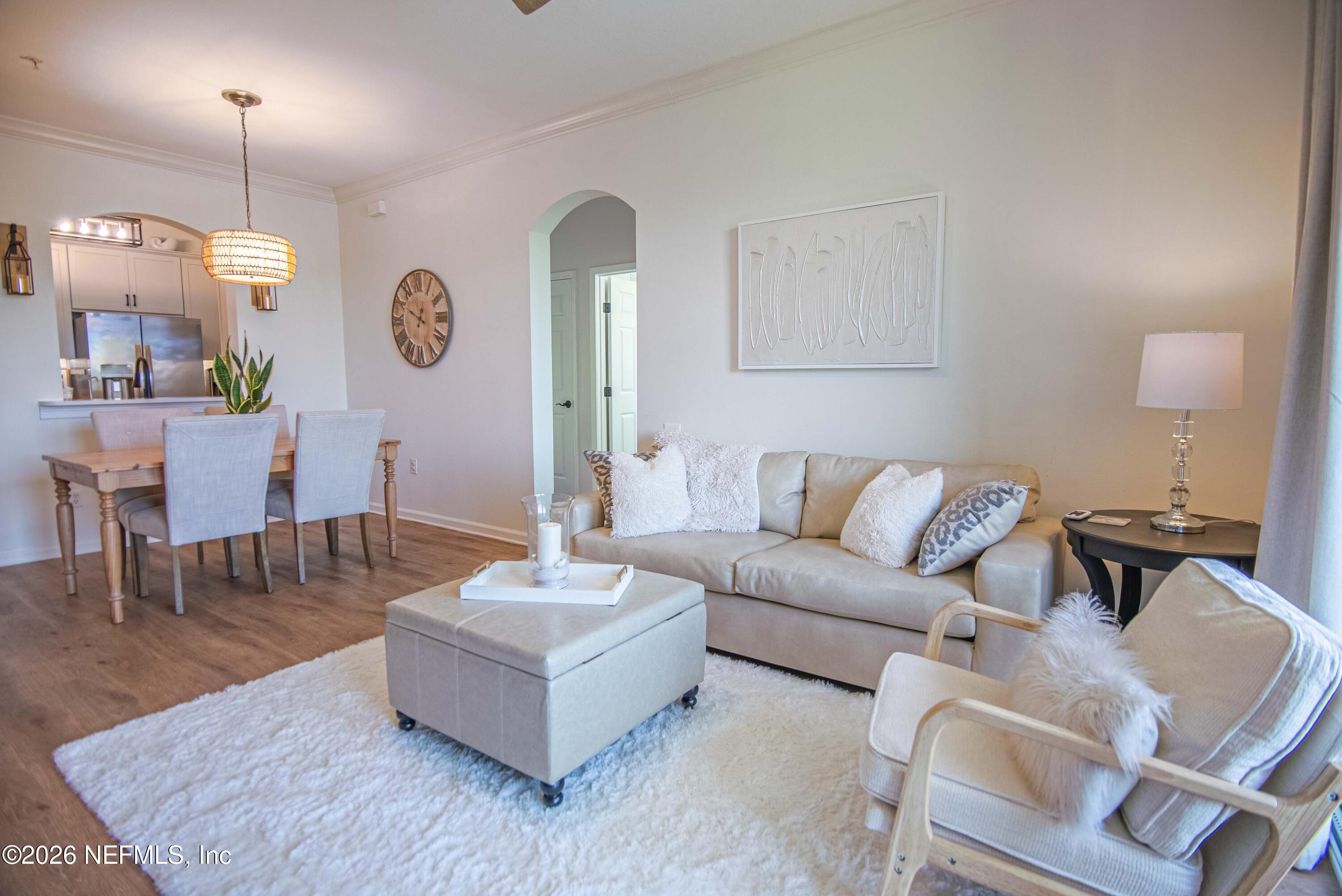 7990 Baymeadows Road East, Unit 823 Jacksonville, FL 32256 - Photo 13 of 45 a living room with furniture and a wooden floor