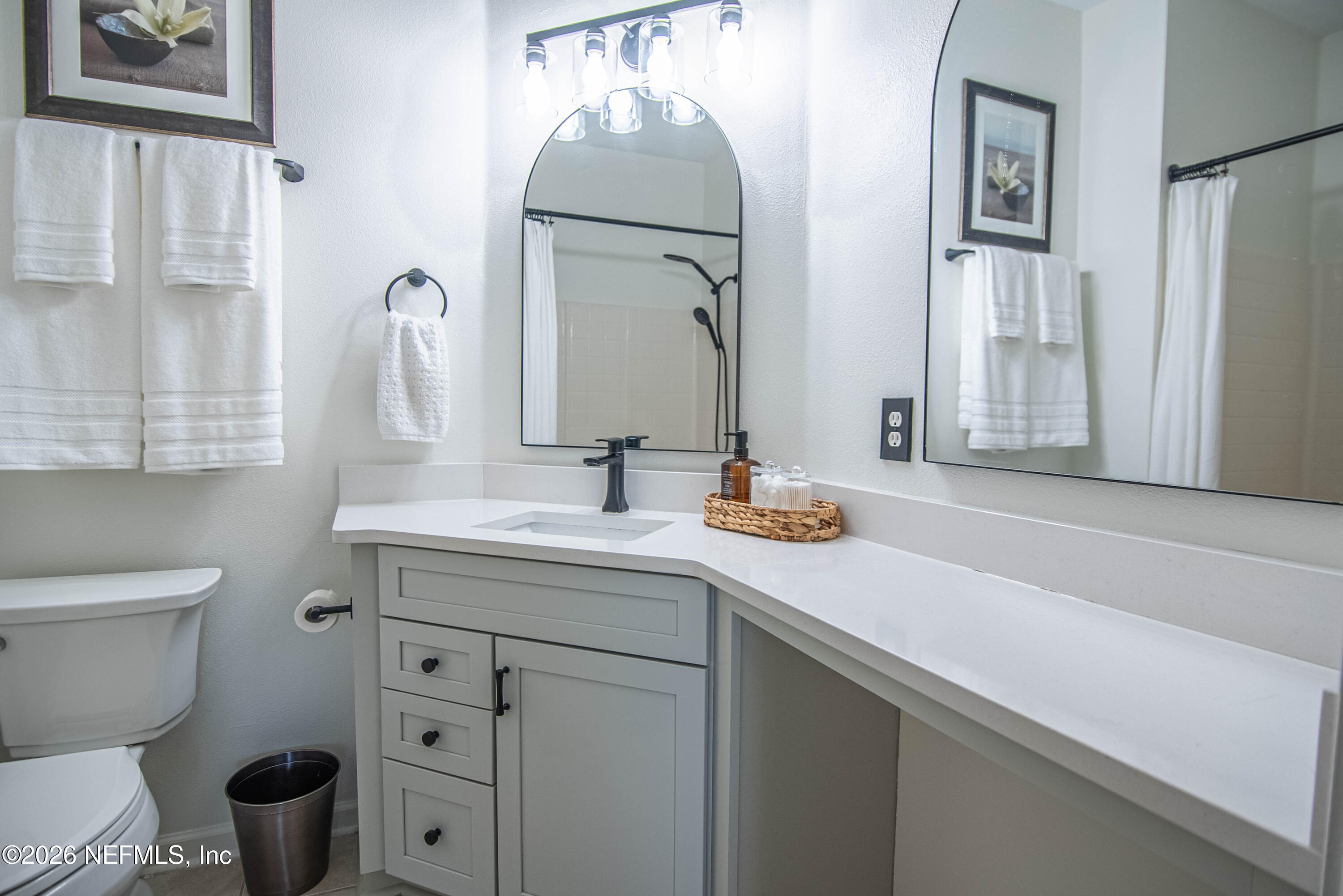 7990 Baymeadows Road East, Unit 823 Jacksonville, FL 32256 - Photo 14 of 45 a bathroom with a sink toilet and mirror