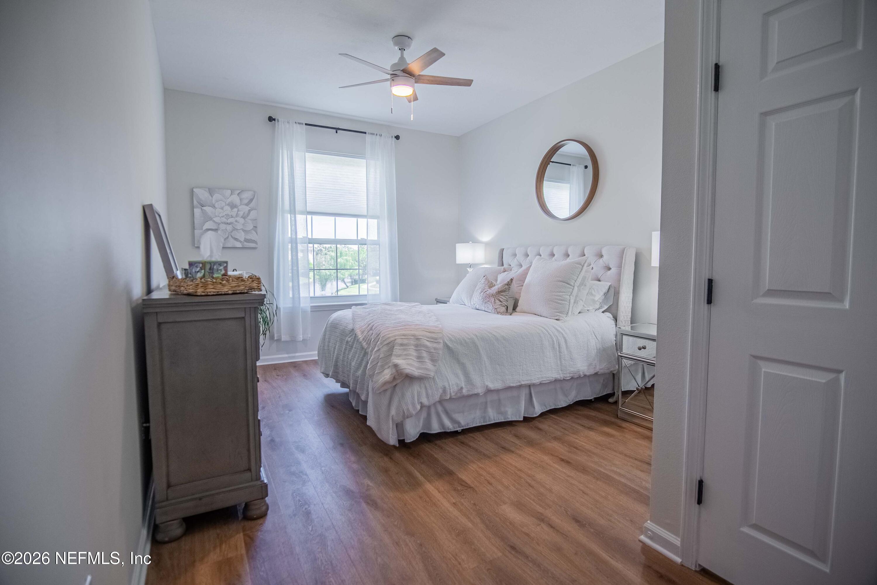 7990 Baymeadows Road East, Unit 823 Jacksonville, FL 32256 - Photo 15 of 45 a bedroom with a bed and a chandelier