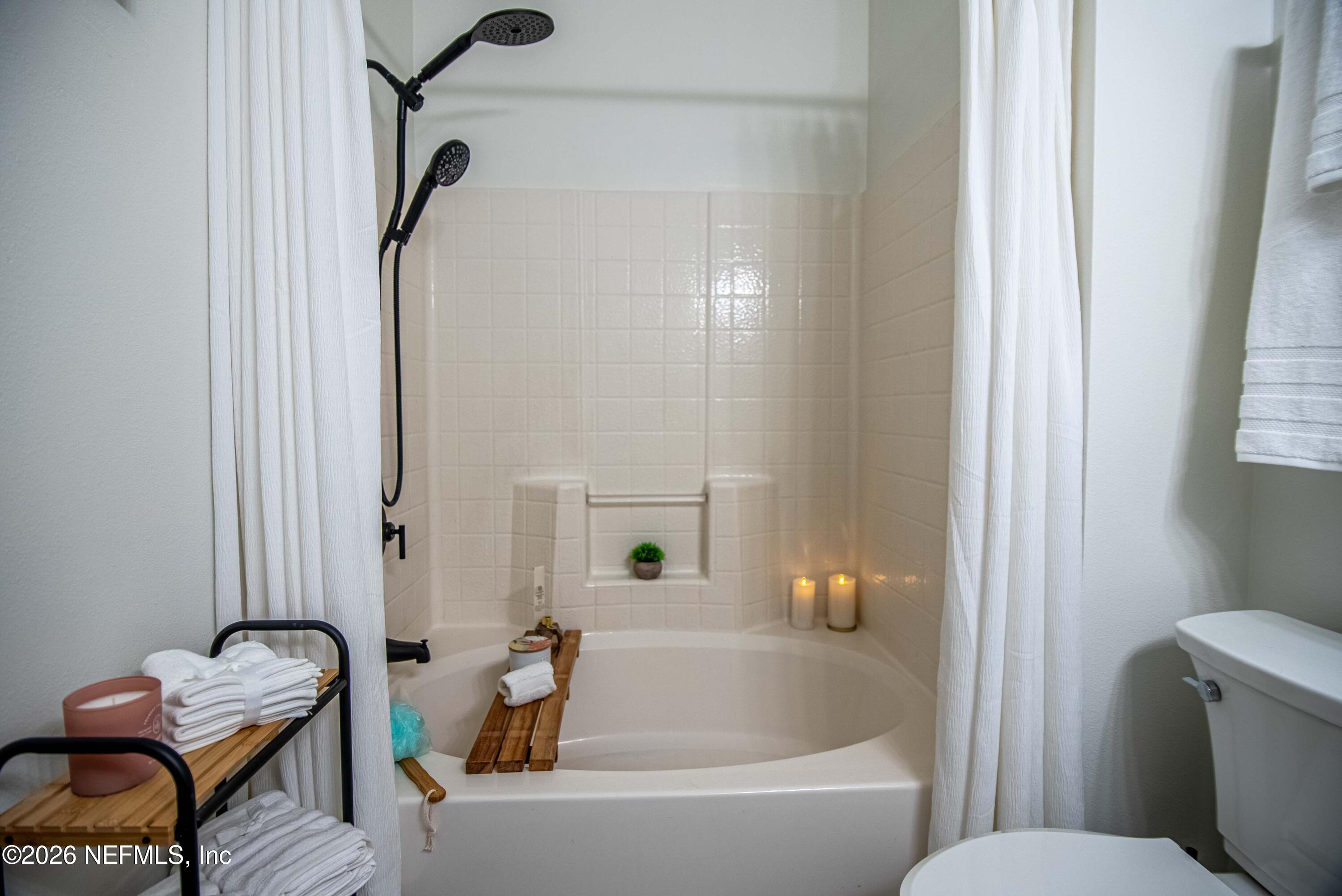 7990 Baymeadows Road East, Unit 823 Jacksonville, FL 32256 - Photo 18 of 45 a bathroom with a tub and shower