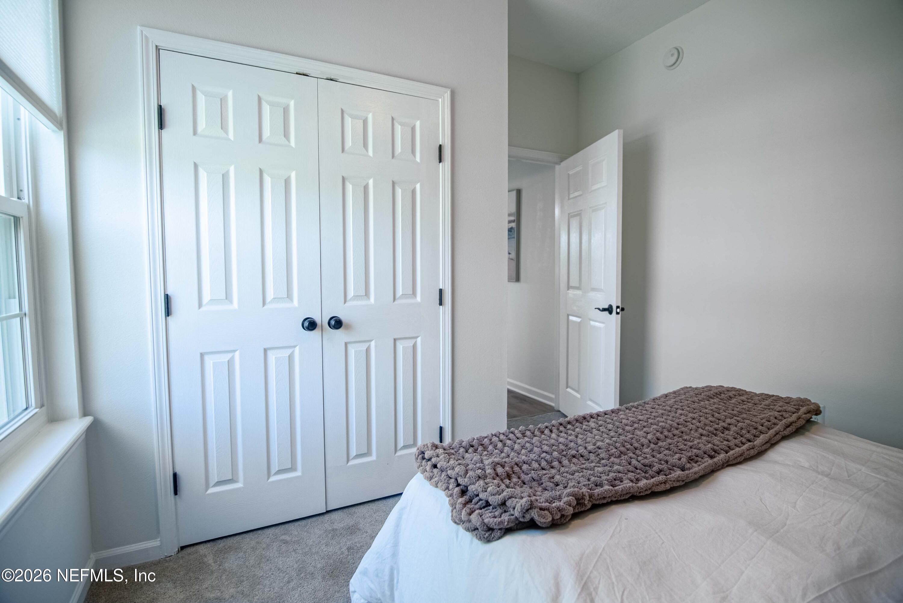 7990 Baymeadows Road East, Unit 823 Jacksonville, FL 32256 - Photo 23 of 45 a bedroom with a bed and a window