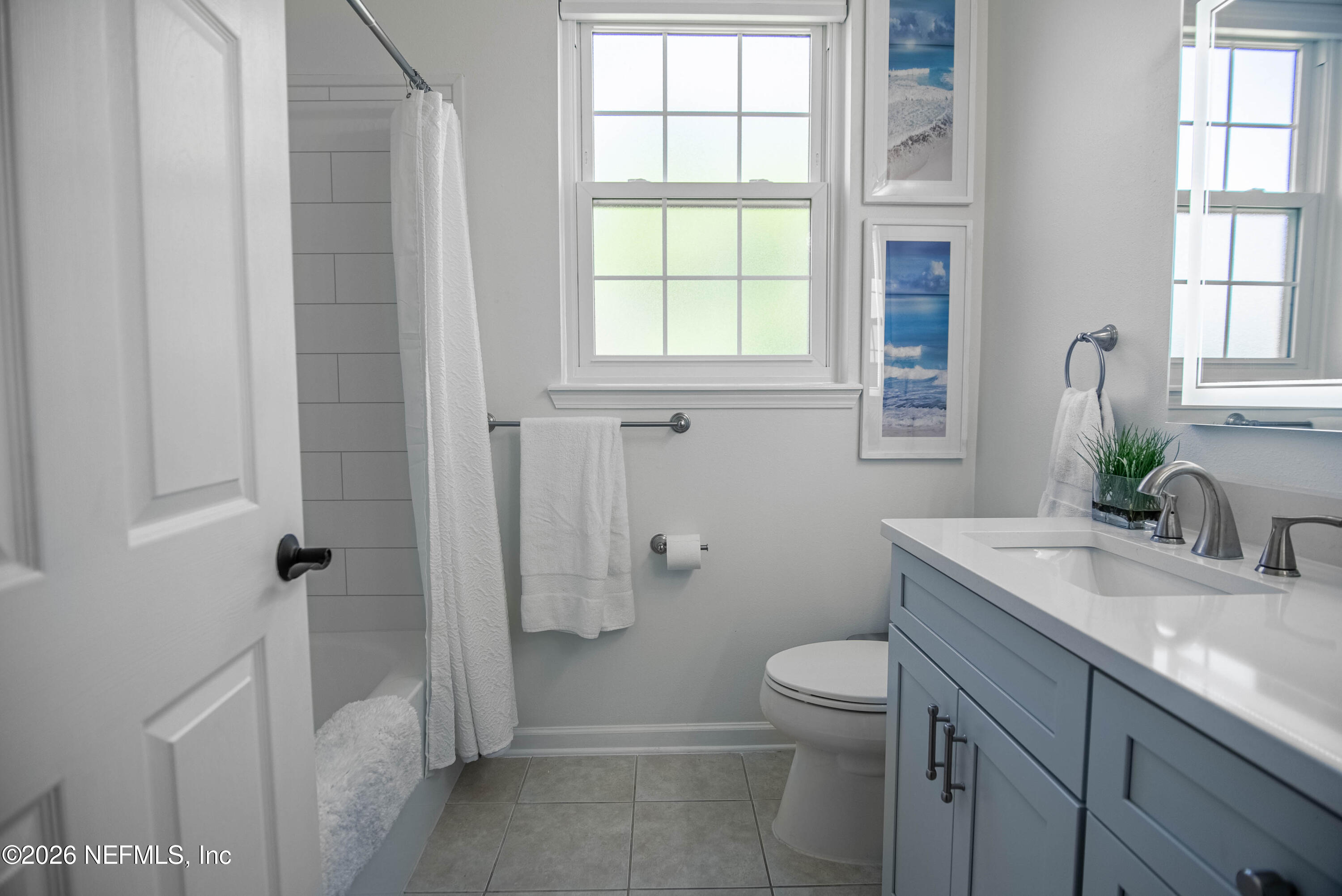 7990 Baymeadows Road East, Unit 823 Jacksonville, FL 32256 - Photo 24 of 45 a bathroom with a granite countertop sink a toilet and a window