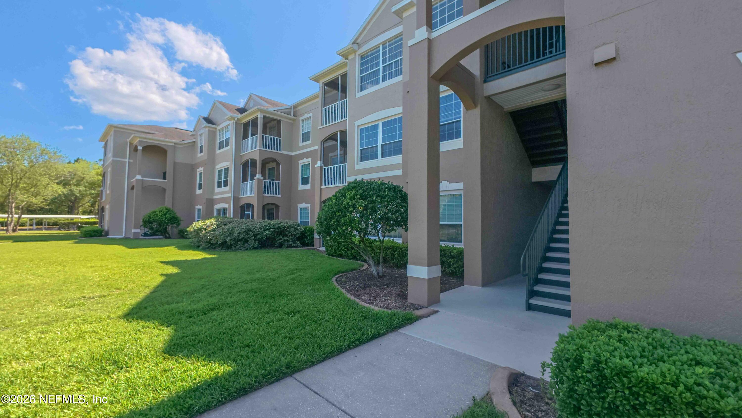 7990 Baymeadows Road East, Unit 823 Jacksonville, FL 32256 - Photo 31 of 45 a view of a building with a yard