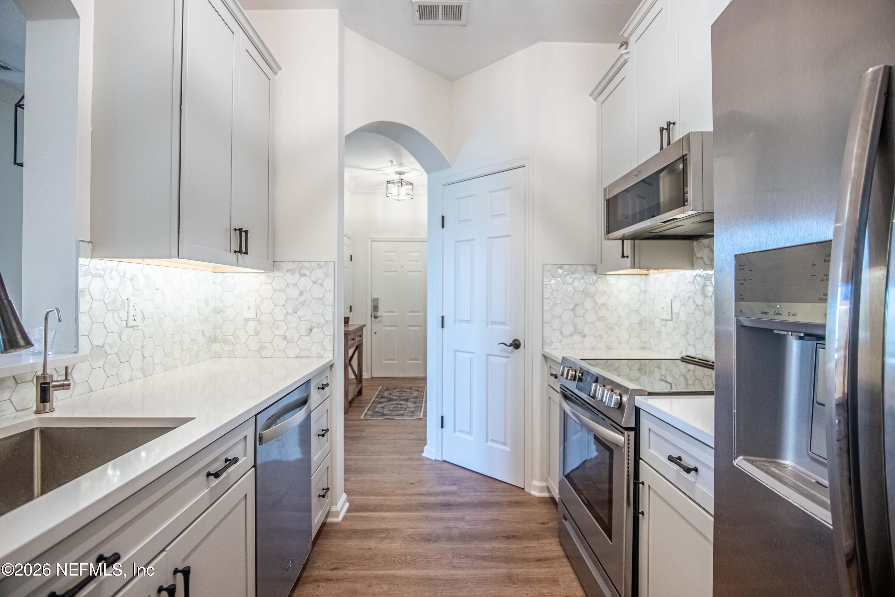7990 Baymeadows Road East, Unit 823 Jacksonville, FL 32256 - Photo 5 of 45 a kitchen with stainless steel appliances granite countertop a sink and a stove