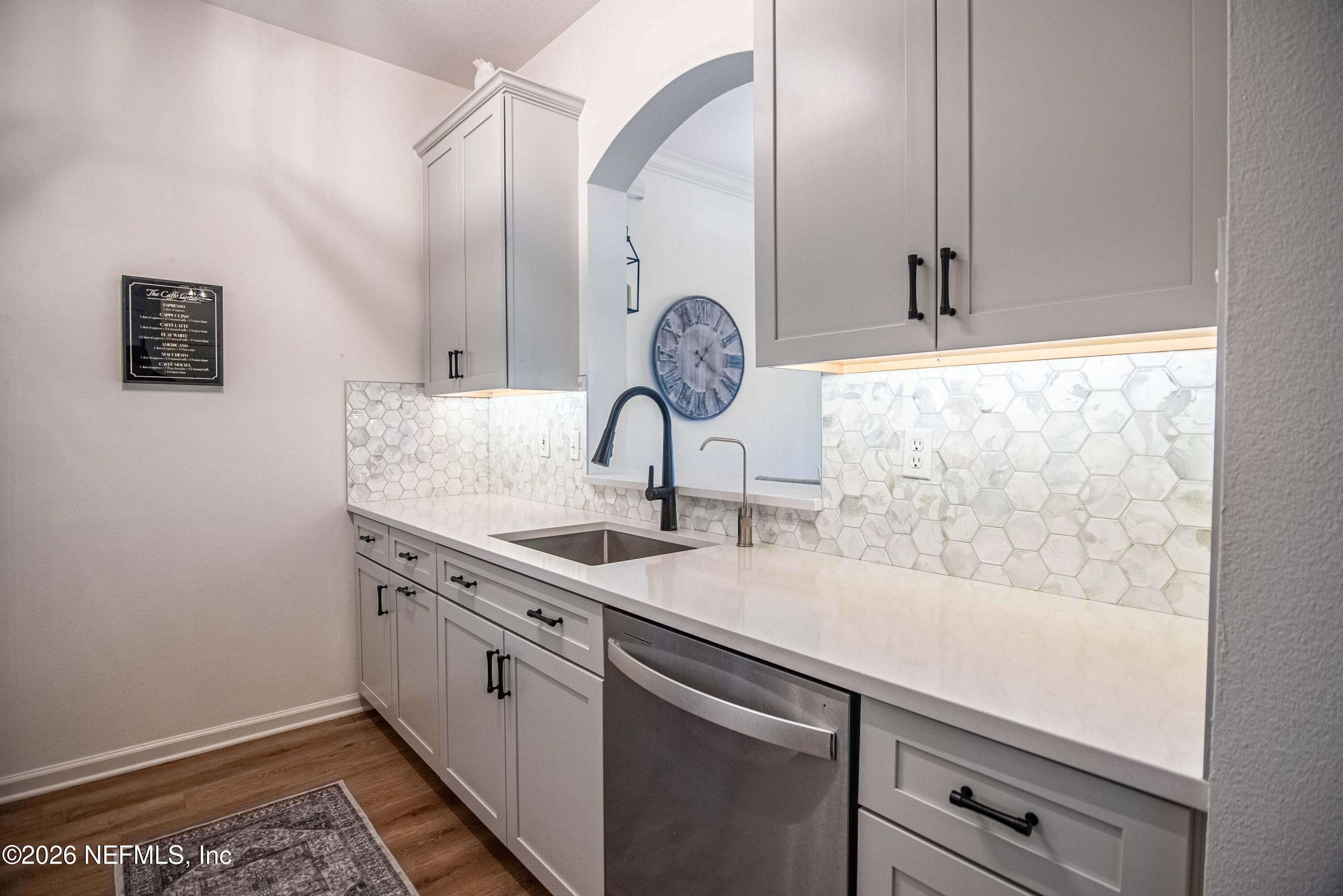 7990 Baymeadows Road East, Unit 823 Jacksonville, FL 32256 - Photo 6 of 45 a view of a sink storage and utility room with washer and dryer