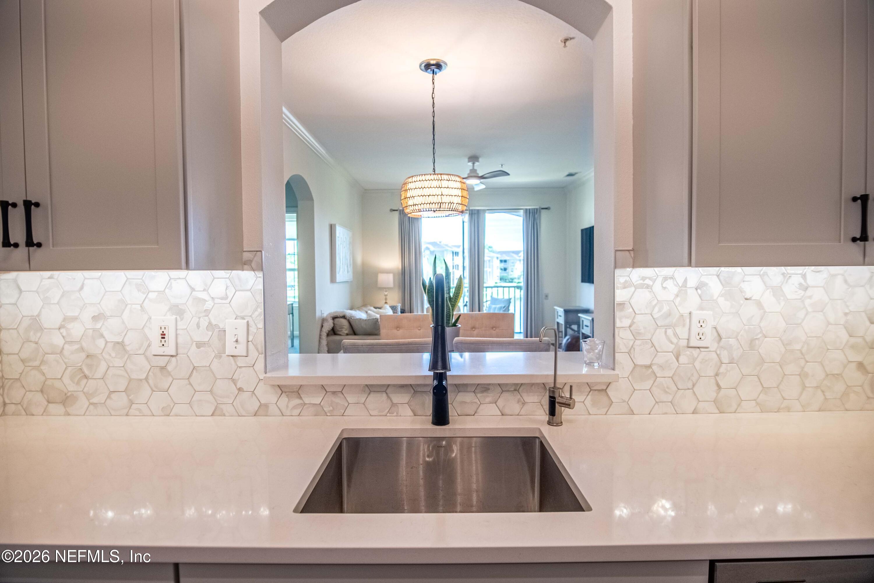 7990 Baymeadows Road East, Unit 823 Jacksonville, FL 32256 - Photo 8 of 45 a view of a living room with a large window and chandelier