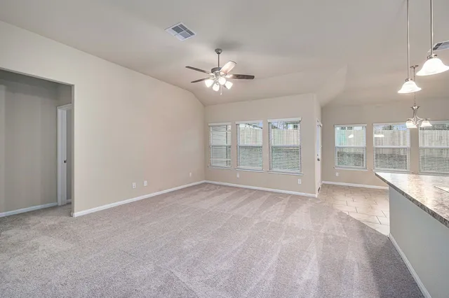 a large white kitchen with kitchen island a sink stainless steel appliances and cabinets