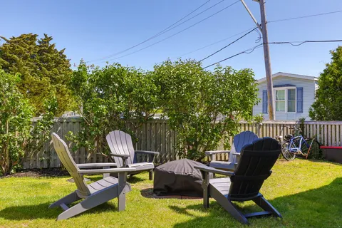a view of a swimming pool with a patio and a yard