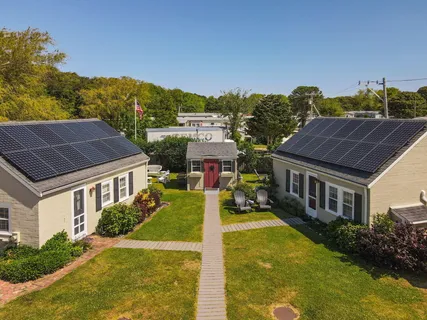 a aerial view of a house with swimming pool and a yard