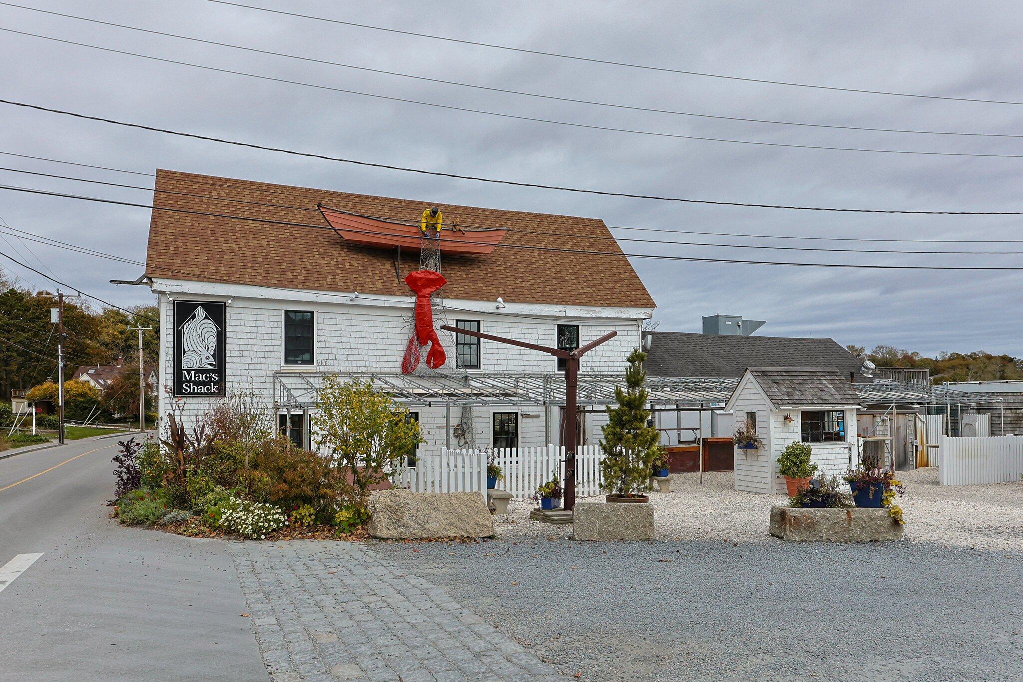 164 Kendrick Avenue, Unit B Wellfleet, MA 02667 - Photo 29 of 32 a front view of a house with a sitting area