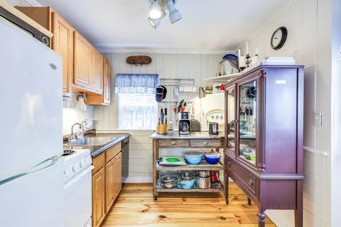 a kitchen with stainless steel appliances granite countertop a sink and cabinets