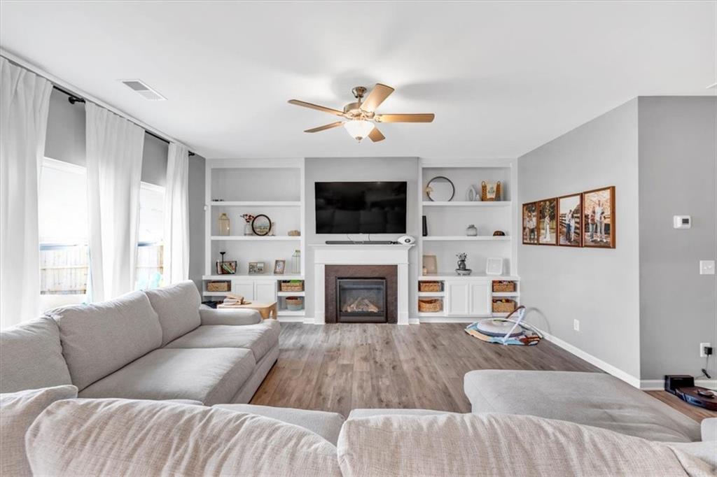 24 Jackson Farm Road Cartersville, GA 30120 - Photo 11 of 50 a living room with furniture a fireplace and a flat screen tv