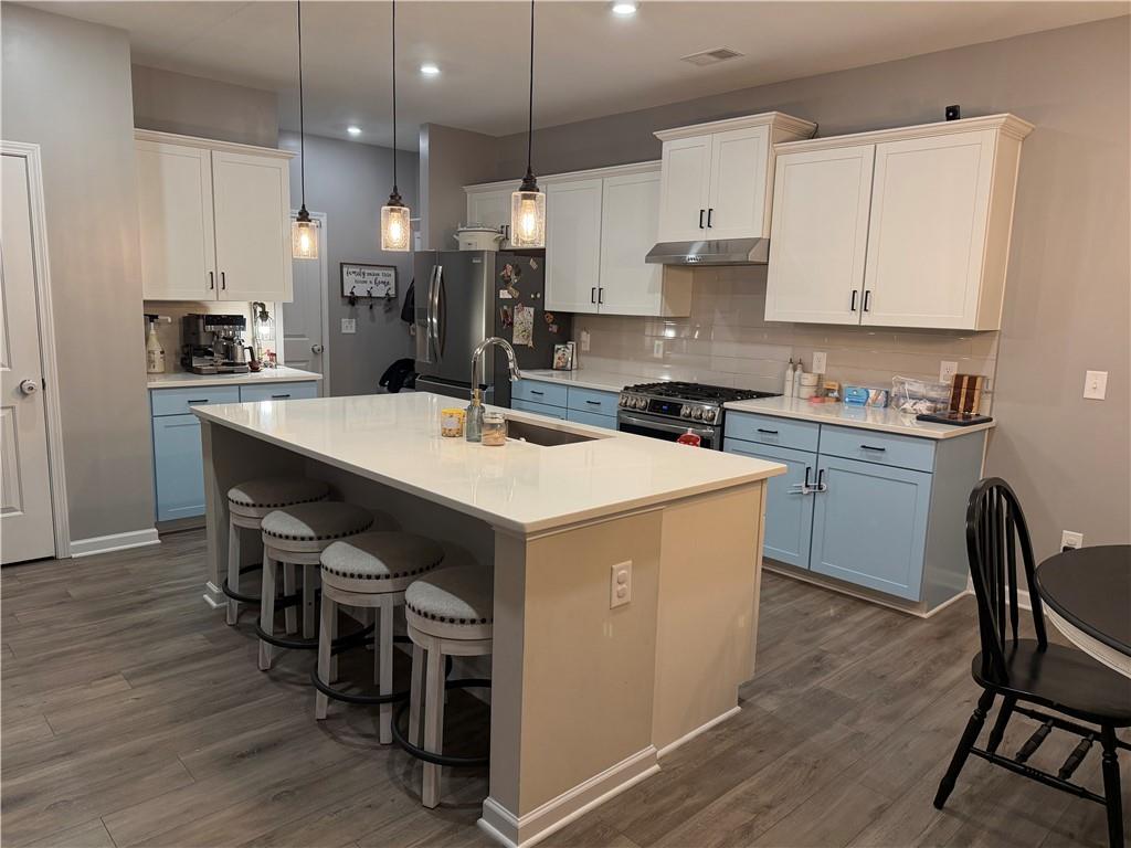 24 Jackson Farm Road Cartersville, GA 30120 - Photo 13 of 50 a kitchen that has a lot of cabinets in it and wooden floors