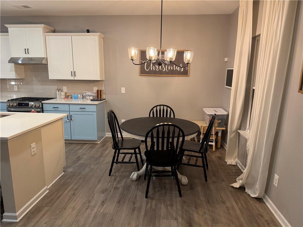 24 Jackson Farm Road Cartersville, GA 30120 - Photo 14 of 50 a view of a dining room with furniture wooden floor and chandelier