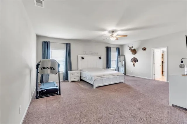 a bedroom with furniture and a book shelf