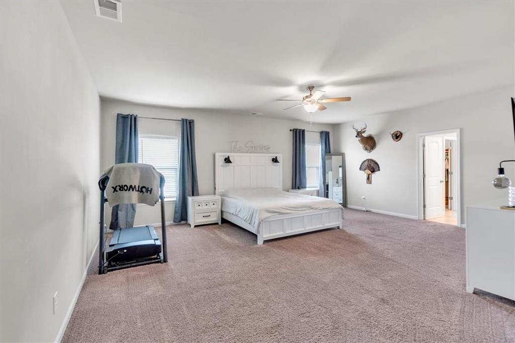 24 Jackson Farm Road Cartersville, GA 30120 - Photo 21 of 50 a spacious bedroom with a bed and a chandelier