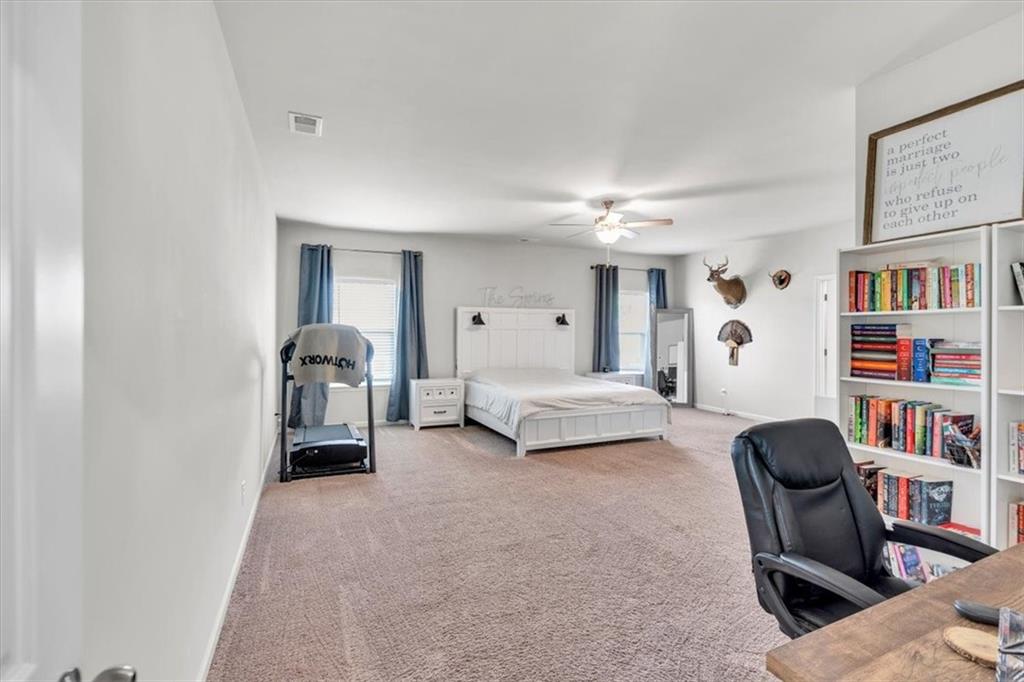 24 Jackson Farm Road Cartersville, GA 30120 - Photo 22 of 50 a bedroom with furniture and a book shelf