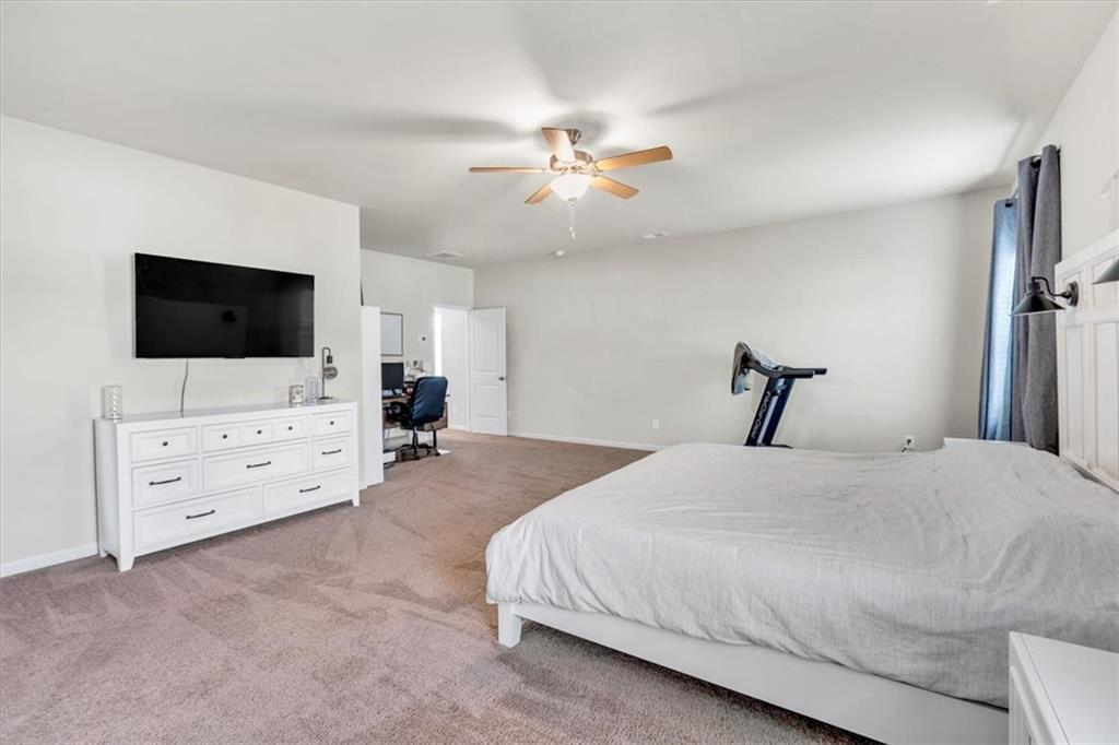 24 Jackson Farm Road Cartersville, GA 30120 - Photo 23 of 50 a bedroom with a bed and a flat screen tv