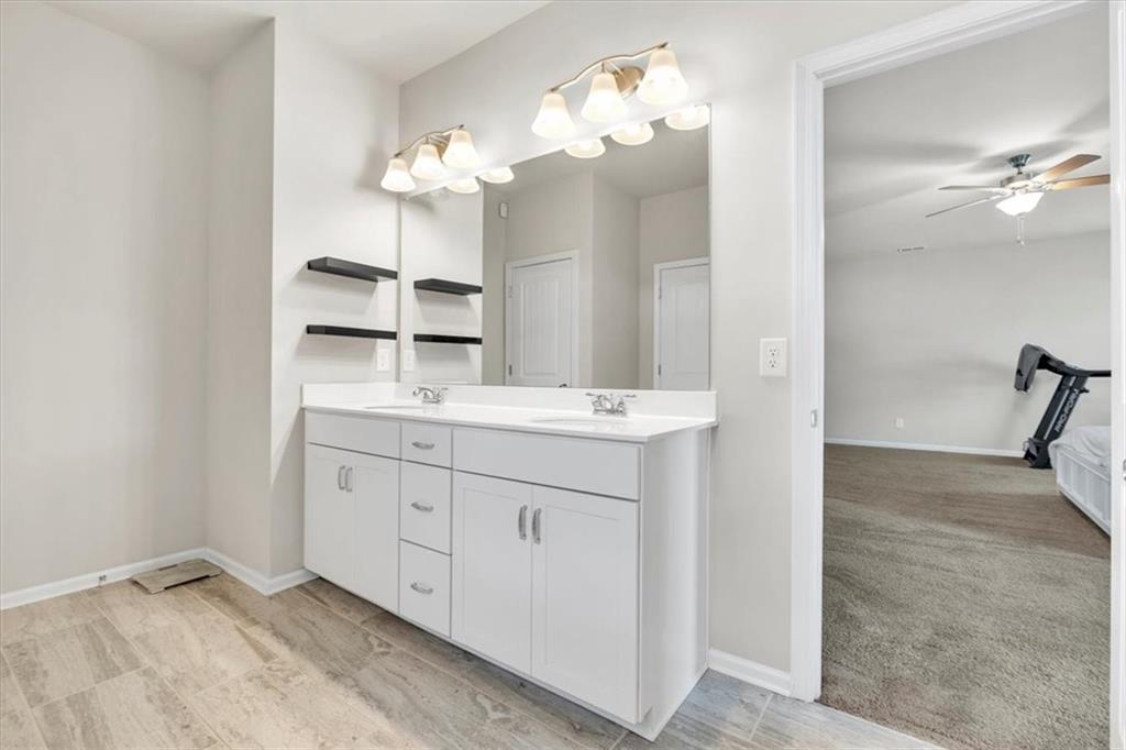 24 Jackson Farm Road Cartersville, GA 30120 - Photo 24 of 50 a bathroom with a double vanity sink and a mirror
