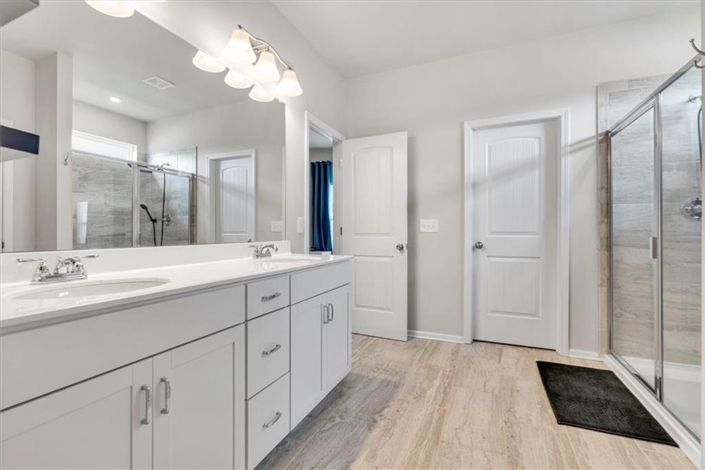 24 Jackson Farm Road Cartersville, GA 30120 - Photo 25 of 50 a spacious bathroom with a double vanity sink a mirror and a shower