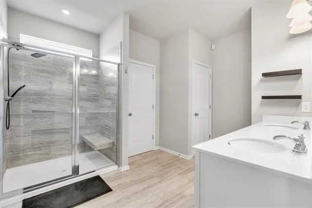 a bathroom with a glass shower door