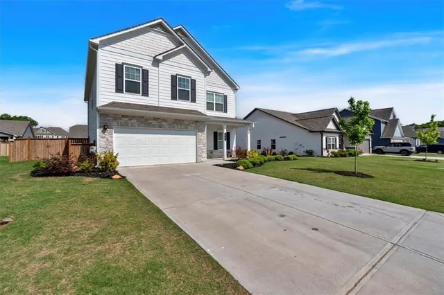 a front view of a house with a yard and garage