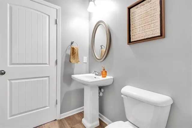 a white toilet sitting next to a white wall