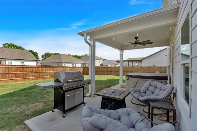 a view of a house with backyard and porch