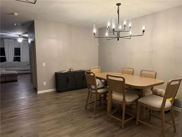 a view of a dining room with furniture wooden floor and chandelier
