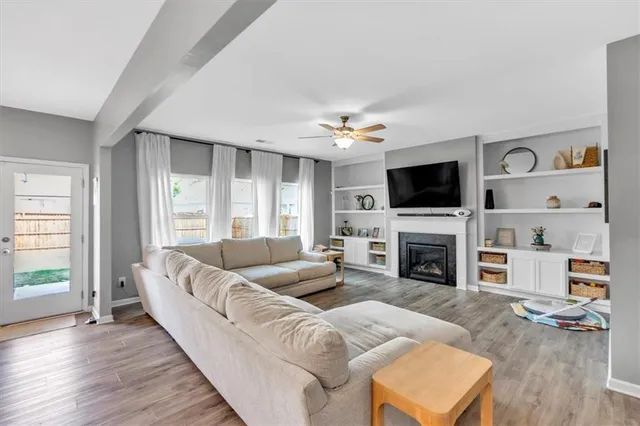 a living room with furniture a fireplace and a flat screen tv
