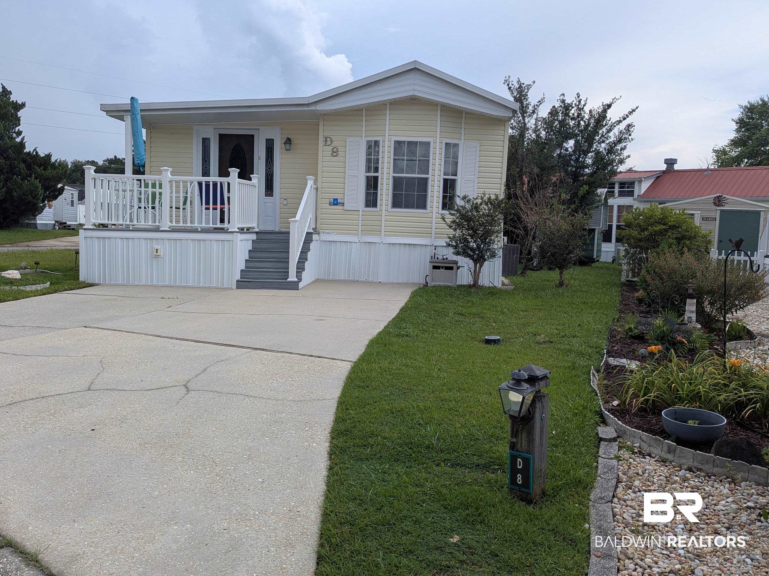 24711 Miflin Road, Unit D8 Elberta, AL 36530 - Photo 1 of 62 Manufactured home with covered porch and a front lawn