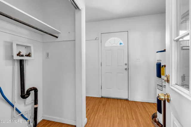 a view of a room with wooden floor and bathroom