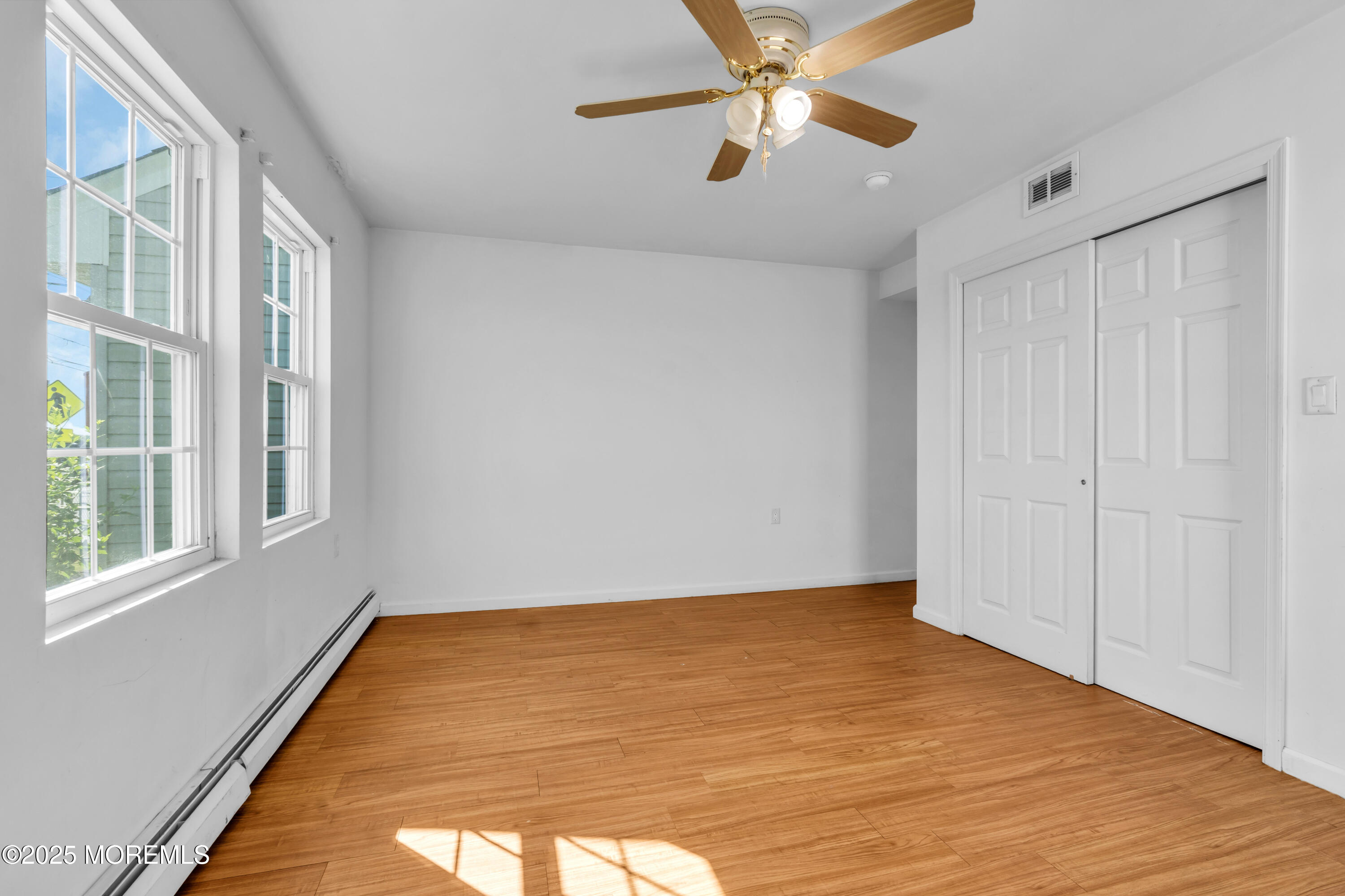 538 Front Street Union Beach, NJ 07735 - Photo 14 of 46 a view of an empty room with a window and wooden floor