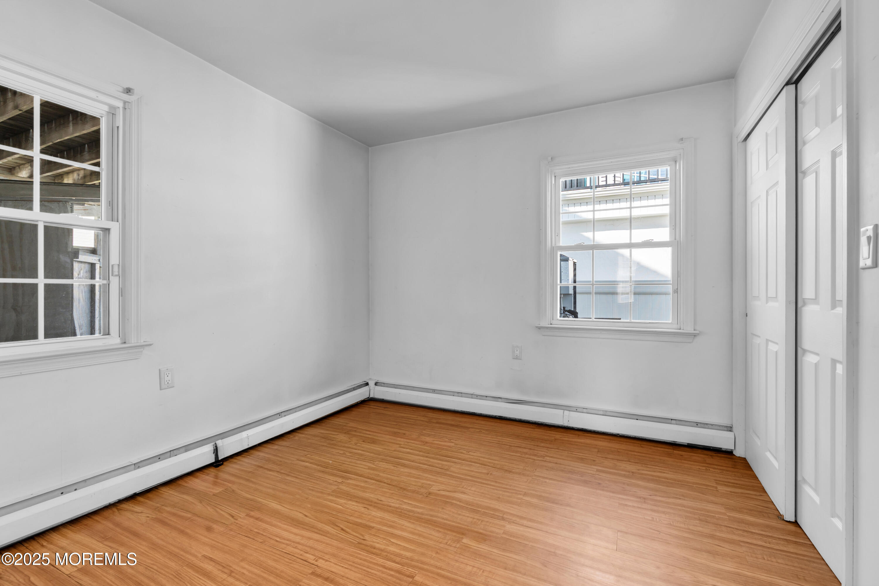 538 Front Street Union Beach, NJ 07735 - Photo 15 of 46 an empty room with wooden floor and windows