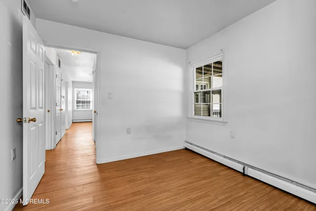 wooden floor in an empty room with a window