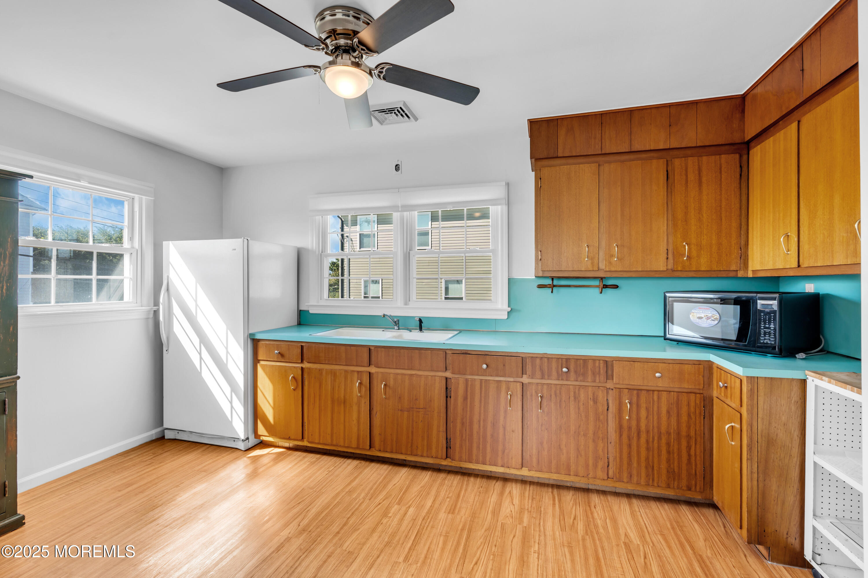 538 Front Street Union Beach, NJ 07735 - Photo 20 of 46 a kitchen with stainless steel appliances granite countertop a sink a stove a refrigerator cabinets and wooden floor