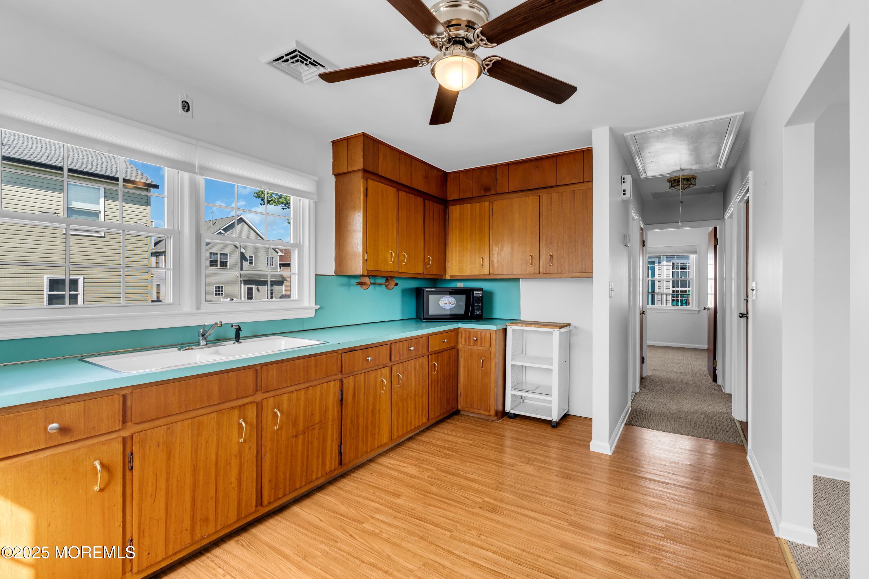 538 Front Street Union Beach, NJ 07735 - Photo 22 of 46 a large kitchen with stainless steel appliances granite countertop a lot of counter space and wooden floors