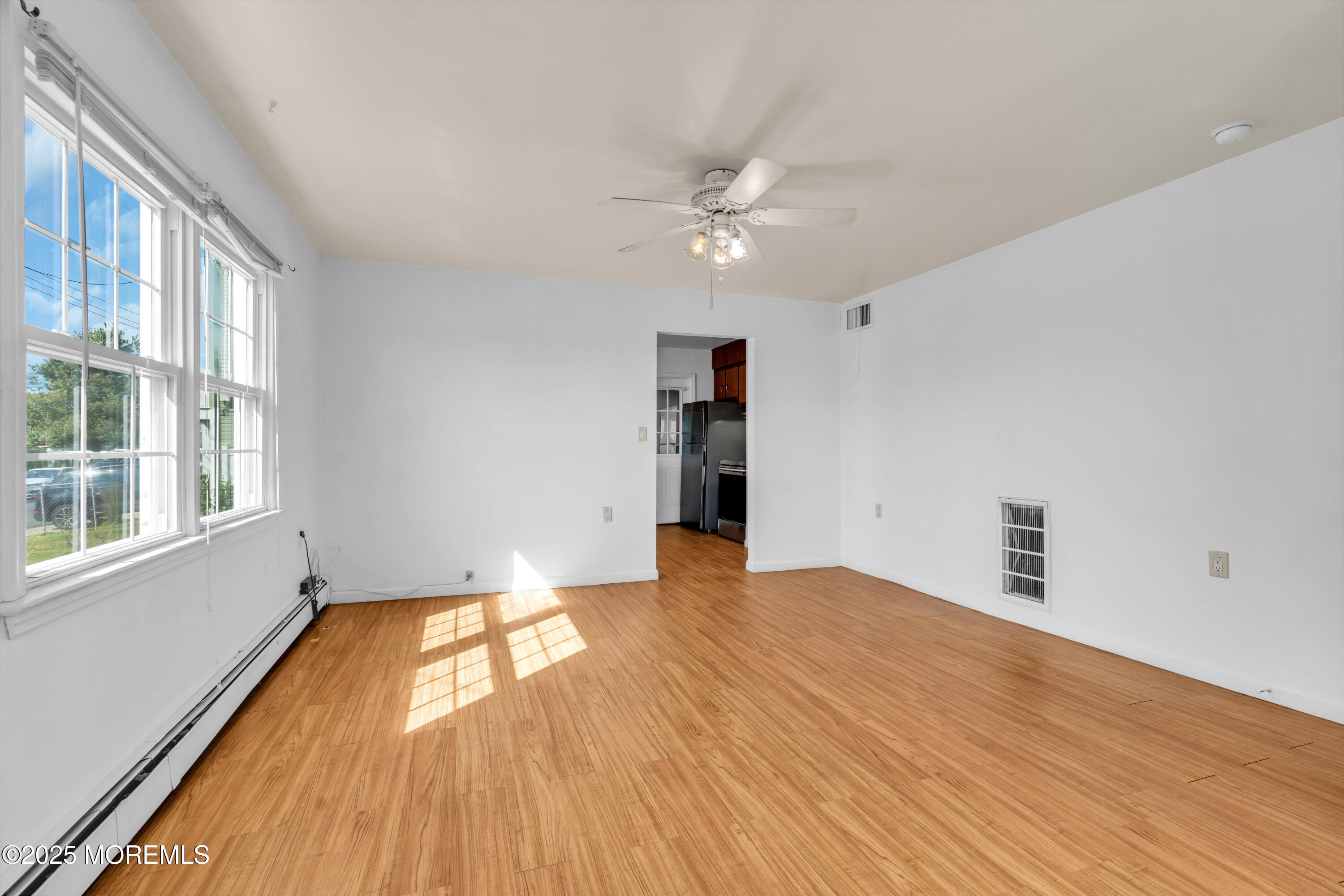 538 Front Street Union Beach, NJ 07735 - Photo 6 of 46 a view of empty room with wooden floor and fan