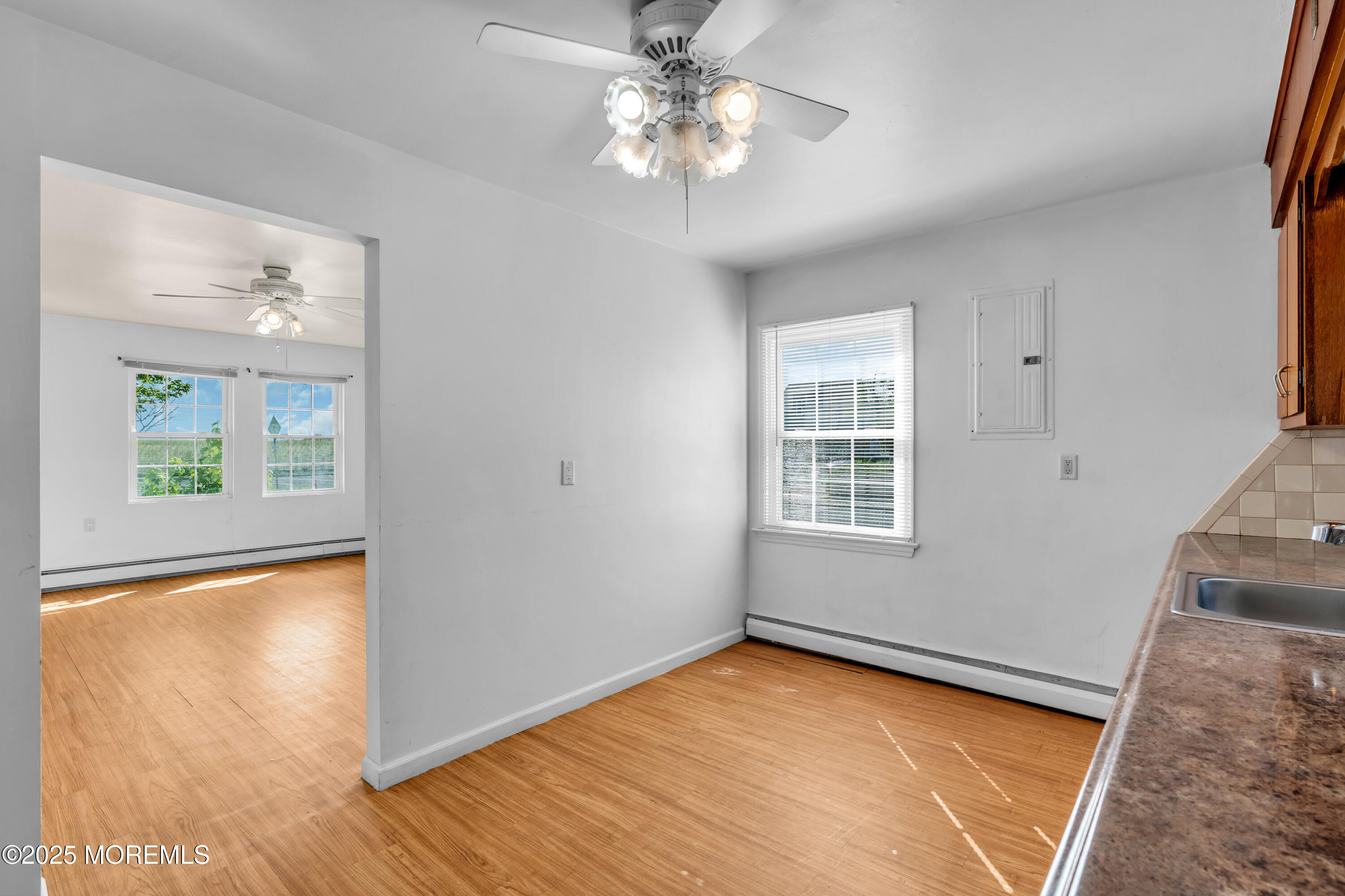 538 Front Street Union Beach, NJ 07735 - Photo 7 of 46 a view of an empty room with a window and wooden floor