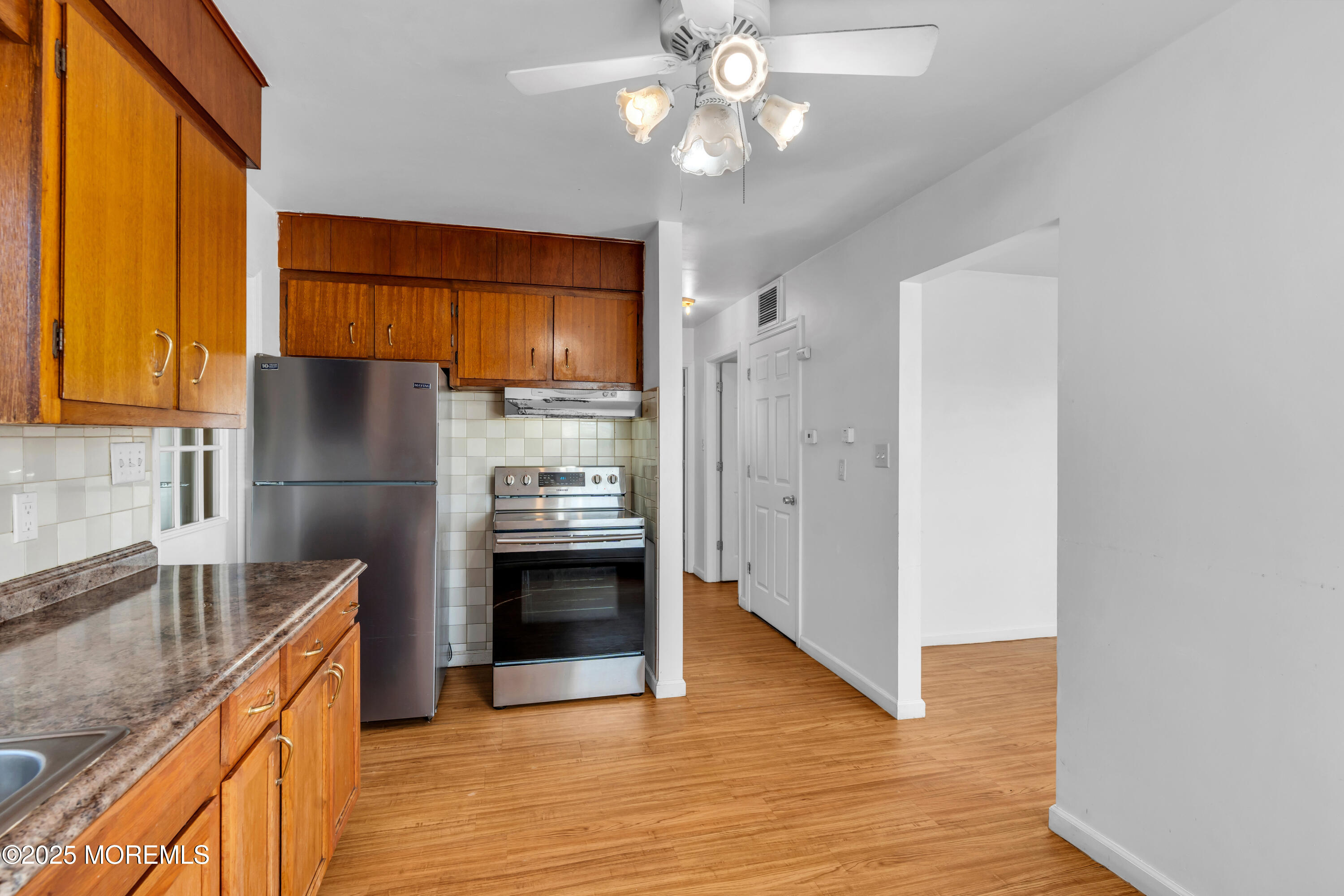 538 Front Street Union Beach, NJ 07735 - Photo 8 of 46 a kitchen with stainless steel appliances granite countertop a refrigerator a sink and a stove
