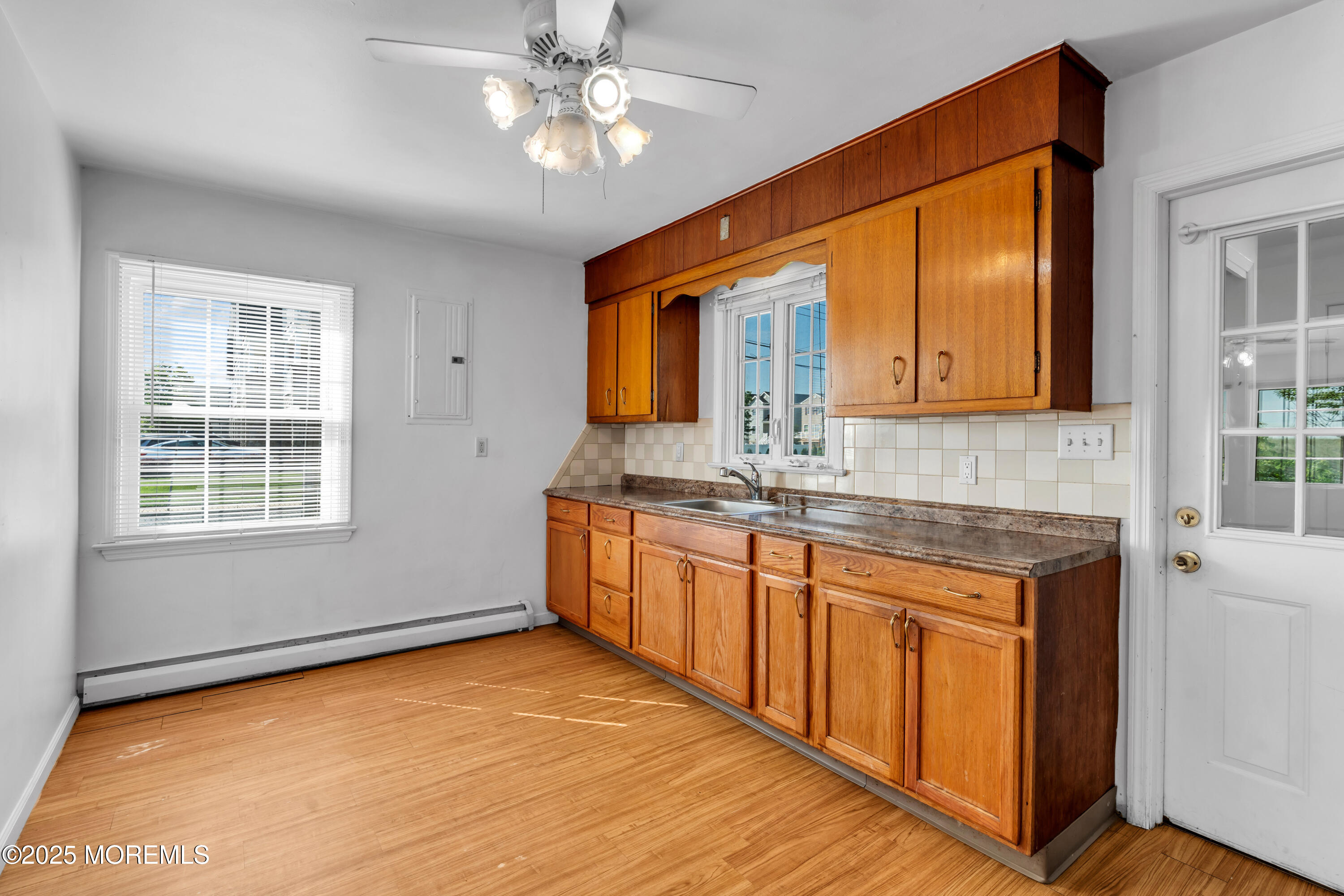 538 Front Street Union Beach, NJ 07735 - Photo 10 of 46 a kitchen with stainless steel appliances granite countertop a sink cabinets and wooden floor