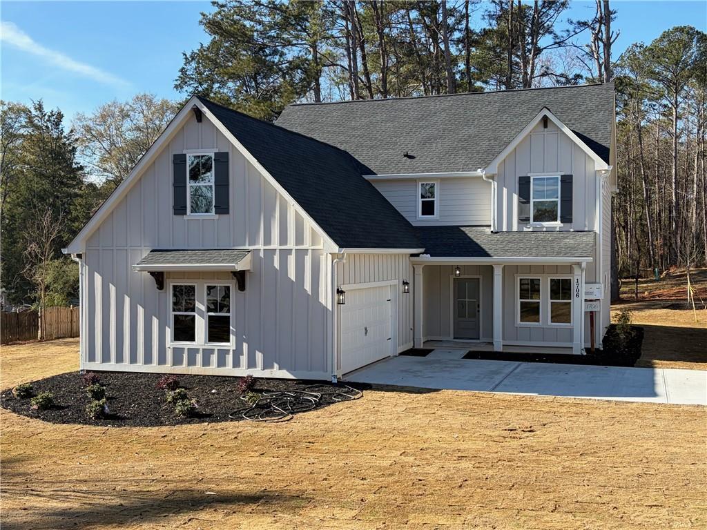 1706 Cunningham Road Southwest Marietta, GA 30008 - Photo 1 of 27 a front view of a house with a yard and garage