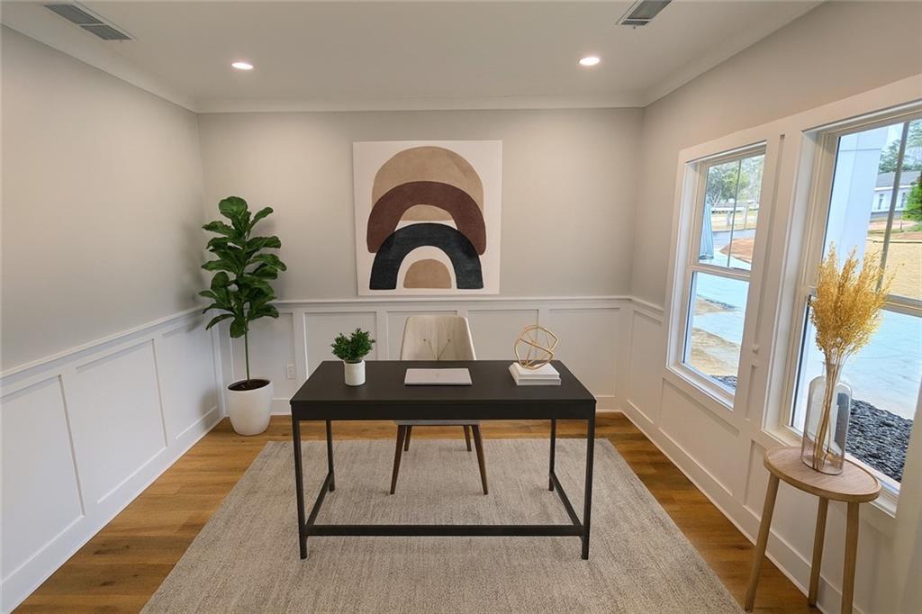 1706 Cunningham Road Southwest Marietta, GA 30008 - Photo 12 of 27 a living room with a couch and a potted plant