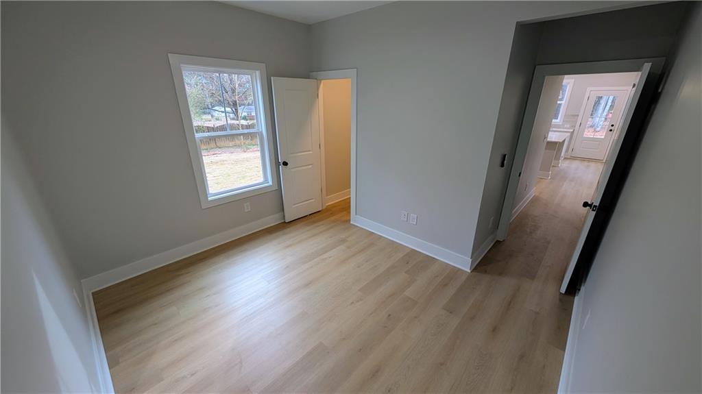 1706 Cunningham Road Southwest Marietta, GA 30008 - Photo 14 of 27 an empty room with wooden floor and windows