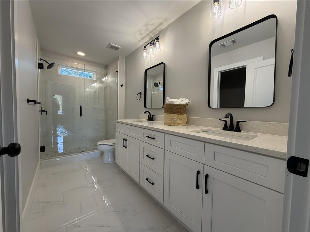 1706 Cunningham Road Southwest Marietta, GA 30008 - Photo 20 of 27 a bathroom with double vanity sink and mirror